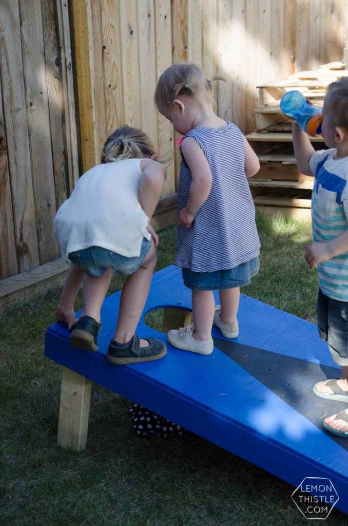 little kids playing cornhole