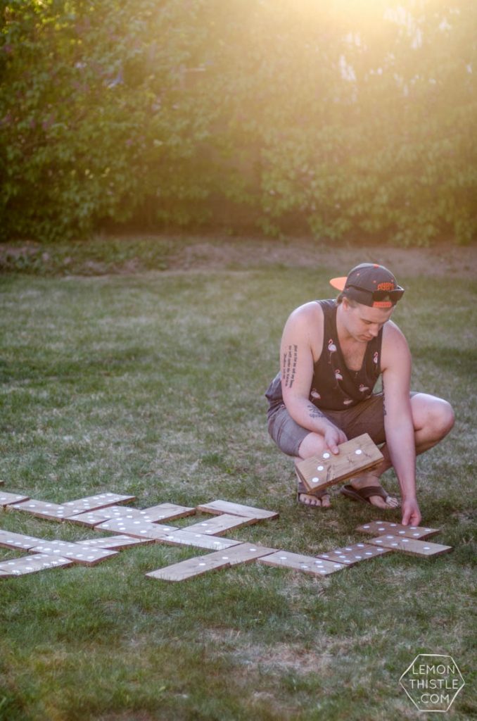 DIY yard games being used in backyard at golden hour- giant dominoes