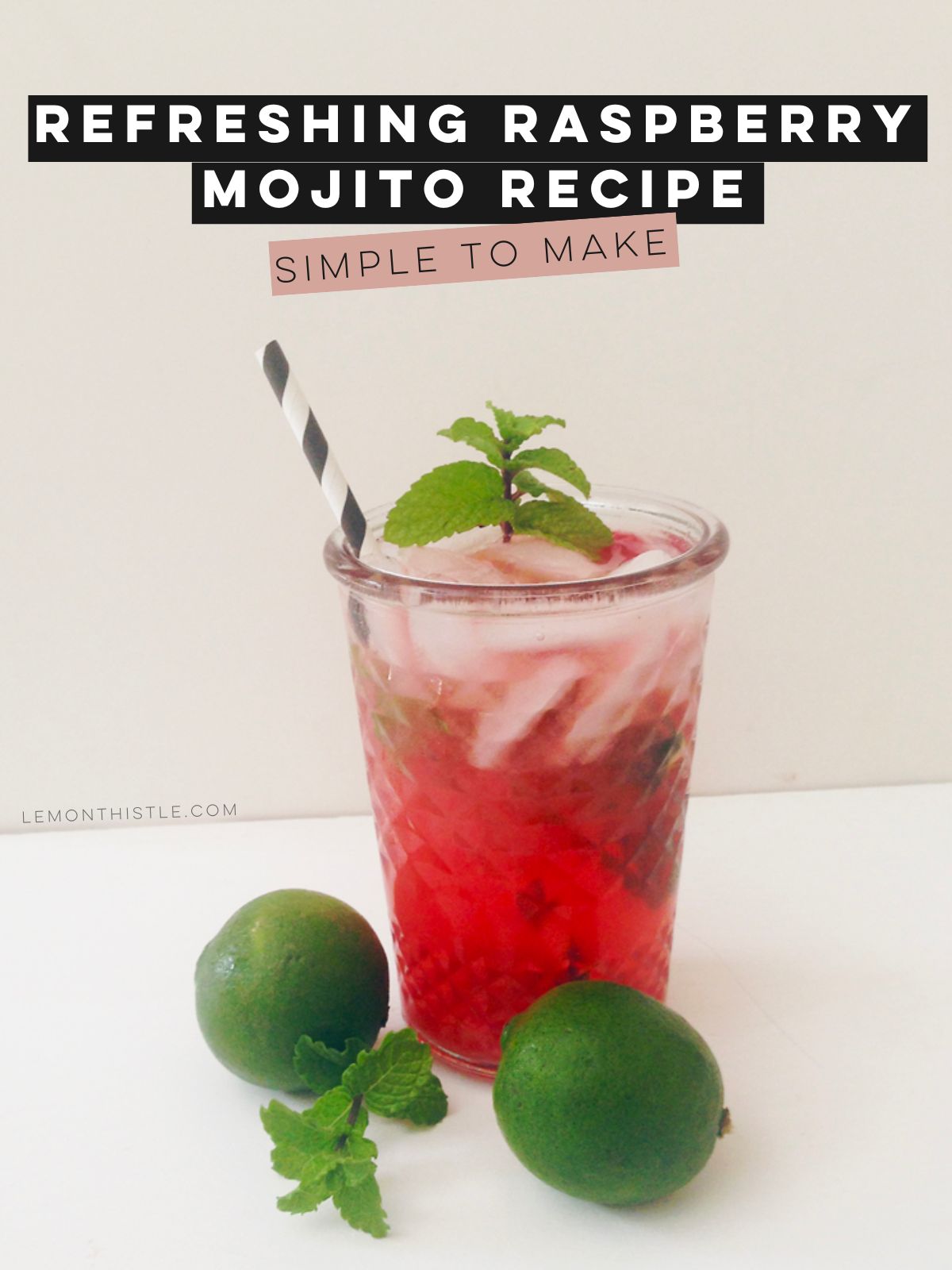 raspberry mojito with mint and a straw poking out surrounded by mint and limes. text over reads: refreshing raspberry mojito recipe (simple to make!)