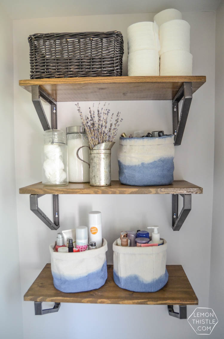 DIY Bathroom Renovation- I love that it breaks it down into stages! I've always wondered if I could renovate in phases. Everything is DIY too, from the tile to the shelf!