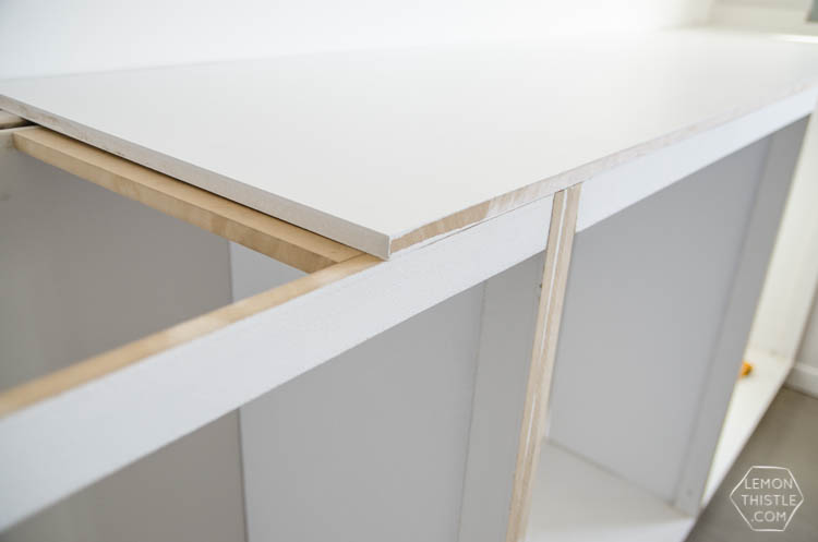 Assembly of built in cabinets for TV and storage- click through for full tutorial