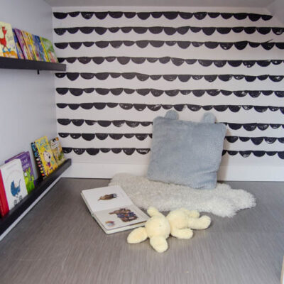 An under stairs nook for kids to play! I love the hand stamped 'wallpaper'. Click through for full tutorial
