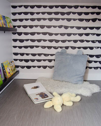 An under stairs nook for kids to play! I love the hand stamped 'wallpaper'. Click through for full tutorial