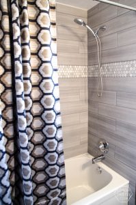 DIY Bathroom Renovation- I love that it breaks it down into stages! I've always wondered if I could renovate in phases. Everything is DIY too, from the tile to the shelf!