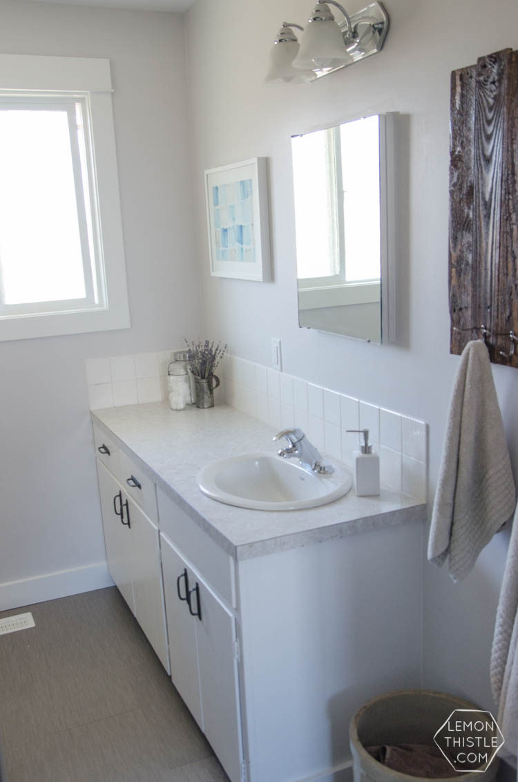 DIY Bathroom Renovation- I love that it breaks it down into stages! I've always wondered if I could renovate in phases. Everything is DIY too, from the tile to the shelf!