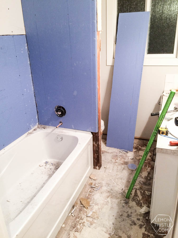 DIY Bathroom Renovation- I love that it breaks it down into stages! I've always wondered if I could renovate in phases. Everything is DIY too, from the tile to the shelf!