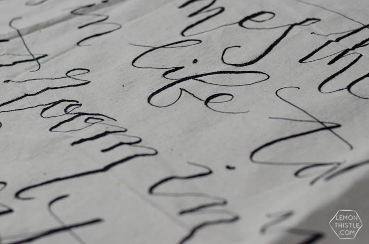 close up of hand lettered canvas wall hanging