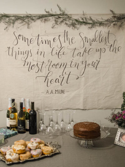I LOVE this DIY giant canvas backdrop for a party... or a nursery. The hand lettering and floral garland is gorgeous! Plus, such great tips to paint thin lines on fabric.