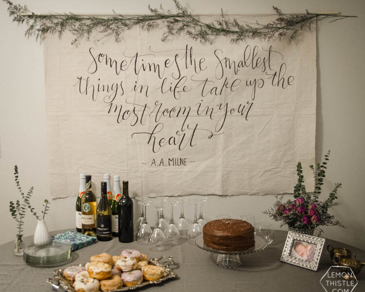 I LOVE this DIY giant canvas backdrop for a party... or a nursery. The hand lettering and floral garland is gorgeous! Plus, such great tips to paint thin lines on fabric.