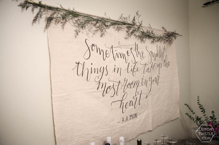 DIY Giant Wall Hanging using a drop cloth and dowel, floral garland along top