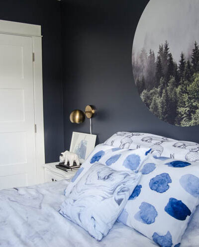 I LOVE this moody navy bedroom- the forrest, the gallery wall- the brass lights... it's all so good! And I love all the DIY