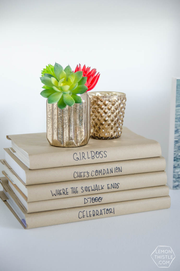 I love this bookshelf refresh! SUCH a big difference. I can't believe the simple book covers do so much. 