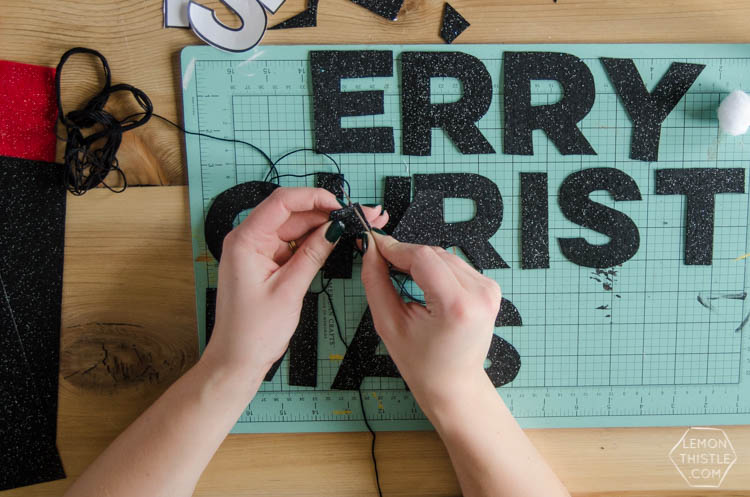 I love this DIY Christmas garland! The modern felt letters are perfect- and the pom pom is a cute detail!