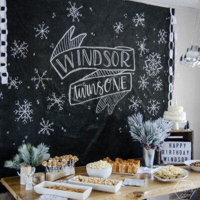 What a clever idea! Using a dropcloth to create a DIY giant chalkboard backdrop for birthday party decorations! Perfect for this modern winter wonderland!