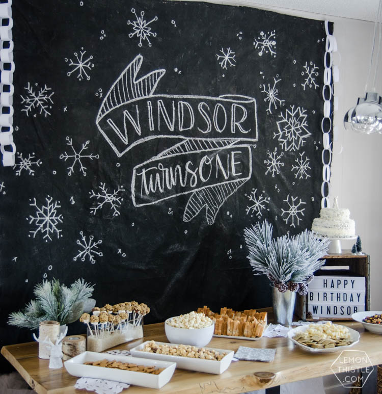What a clever idea! Using a dropcloth to create a DIY giant chalkboard backdrop for birthday party decorations! Perfect for this modern winter wonderland!