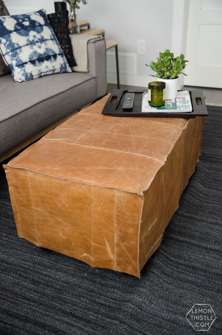 What a great way to bring a storage ottoman up to date! DIY Leather Slip Cover (from reclaimed leather)
