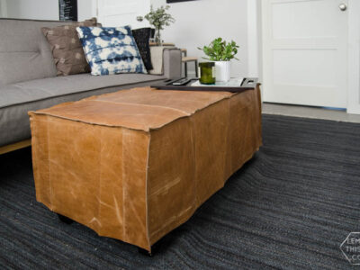 What a great way to bring a storage ottoman up to date! DIY Leather Slip Cover (from reclaimed leather)