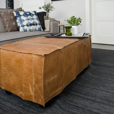 What a great way to bring a storage ottoman up to date! DIY Leather Slip Cover (from reclaimed leather)