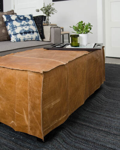 What a great way to bring a storage ottoman up to date! DIY Leather Slip Cover (from reclaimed leather)