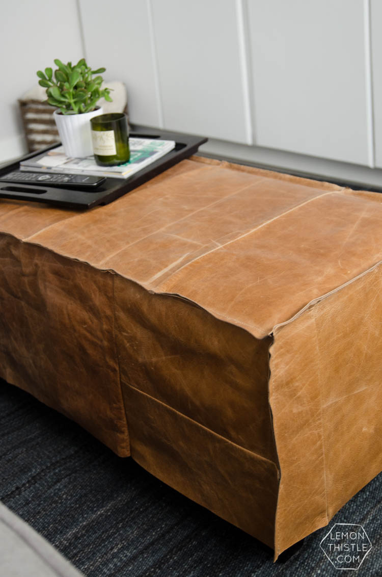 What a great way to bring a storage ottoman up to date! DIY Leather Slip Cover (from reclaimed leather)