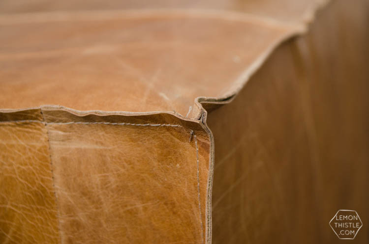 What a great way to bring a storage ottoman up to date! DIY Leather Slip Cover (from reclaimed leather)