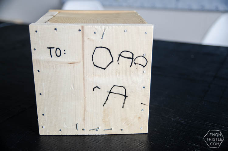 Wooden crate labeled 'to dad' with gift card inside