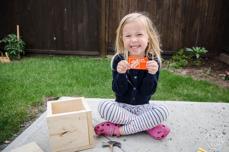 Girl Holding Home Depot Gift Card