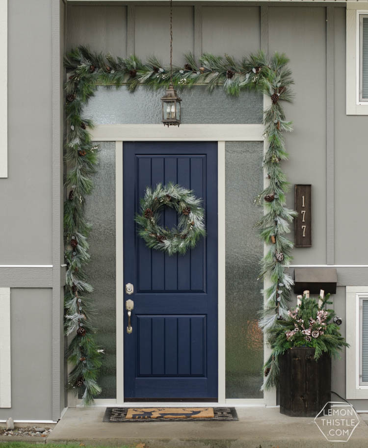 A modern holiday entry way- love the frosted greens and simple black planter- perfect for christmas