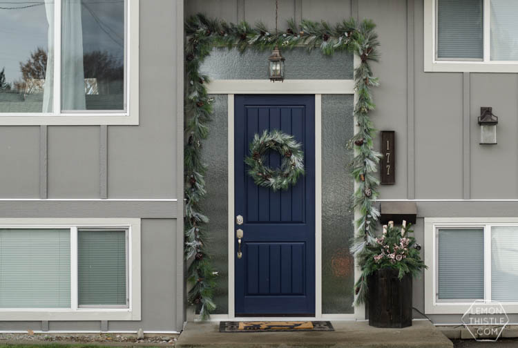 A modern holiday entry way- love the frosted greens and simple black planter- perfect for christmas