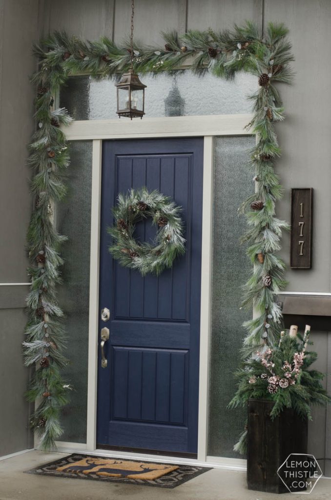 A modern holiday entry way- love the frosted greens and simple black planter- perfect for christmas