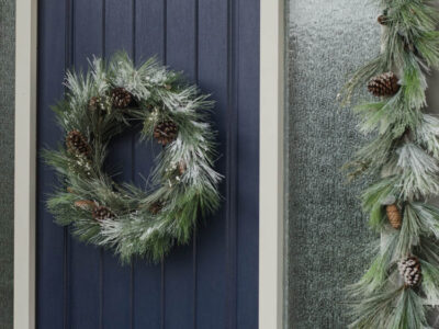 A modern holiday entry way- love the frosted greens and simple black planter- perfect for christmas