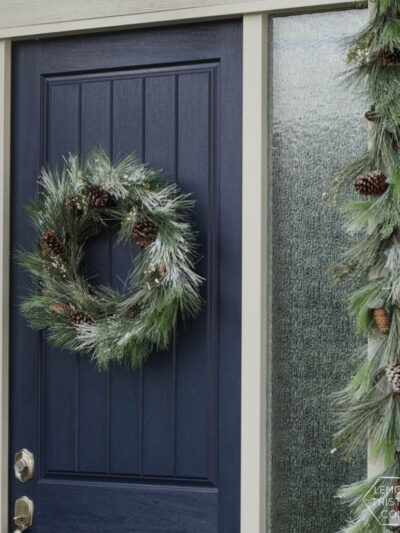 A modern holiday entry way- love the frosted greens and simple black planter- perfect for christmas