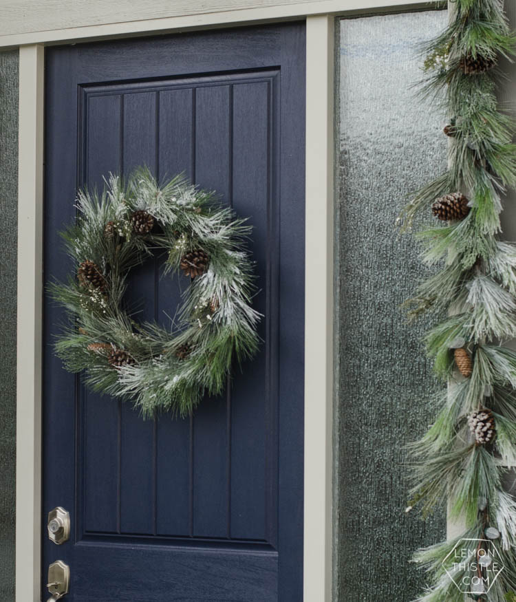 A modern holiday entry way- love the frosted greens and simple black planter- perfect for christmas