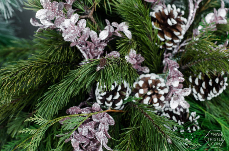 A modern holiday entry way- love the frosted greens and simple black planter- perfect for christmas