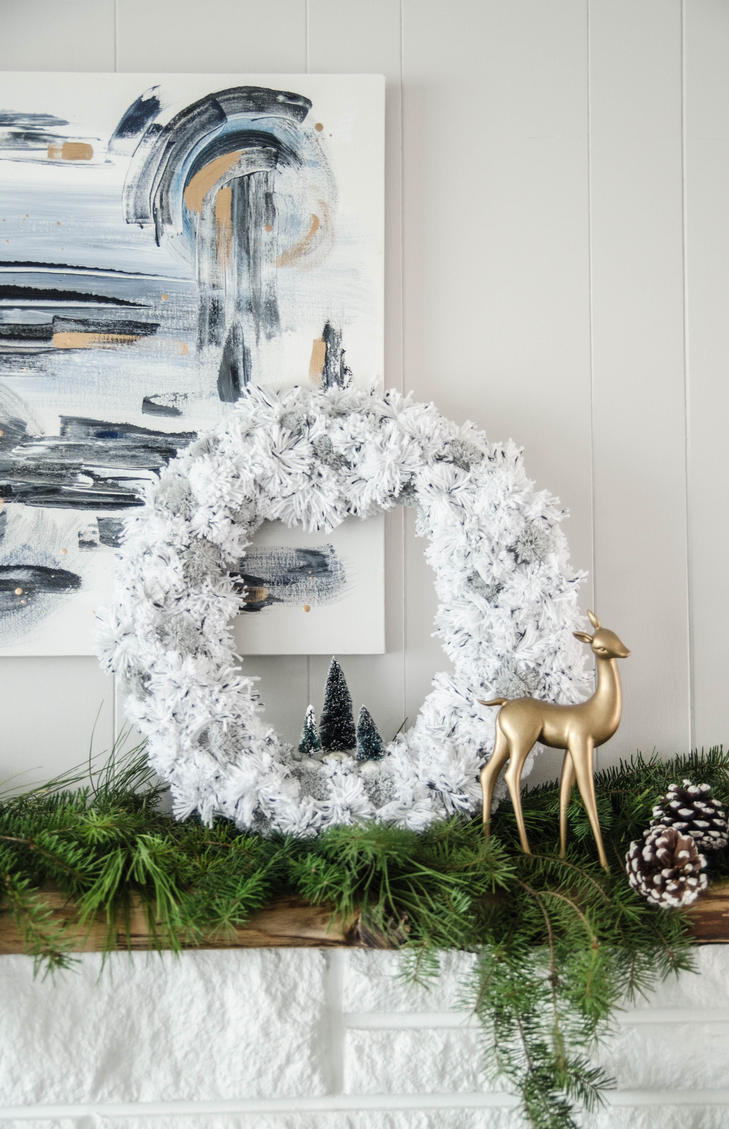 DIY Pom Pom Wreath for the holidays- love the bottle brush trees in there!
