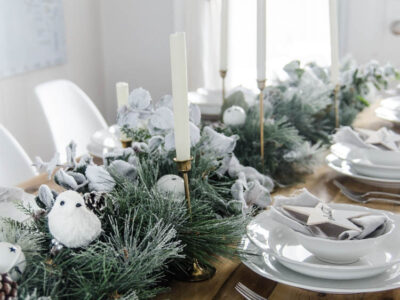 So pretty! A frosted holiday tablescape- DIY place cards and simple garland table runner... perfect for Christmas or any winter dinner party!