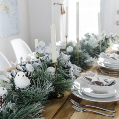 So pretty! A frosted holiday tablescape- DIY place cards and simple garland table runner... perfect for Christmas or any winter dinner party!