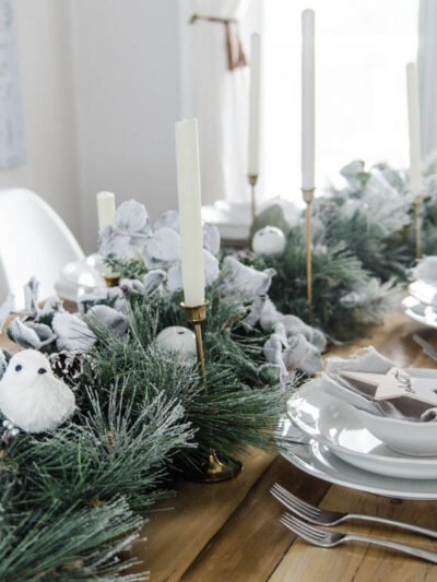 So pretty! A frosted holiday tablescape- DIY place cards and simple garland table runner... perfect for Christmas or any winter dinner party!