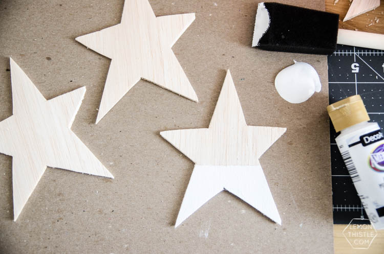 DIY Paint Dipped Wooden Star Place Cards- love that you don't need any tools to cut these wood stars! Such beautiful place settings that can be taken home as gifts after the dinner party