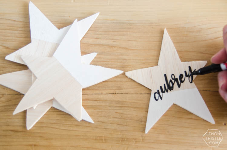 DIY Paint Dipped Wooden Star Place Cards- love that you don't need any tools to cut these wood stars! Such beautiful place settings that can be taken home as gifts after the dinner party