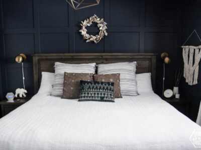 King bed with white quilted duvet cover and moulding feature wall