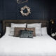 King bed with white quilted duvet cover and moulding feature wall