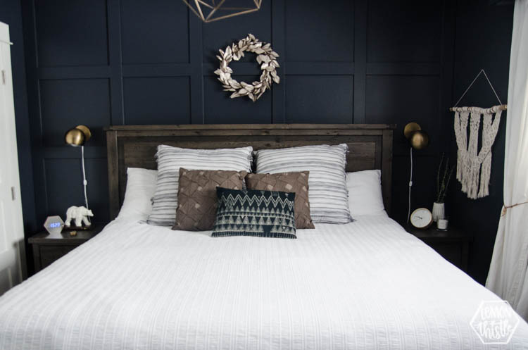 King bed with white quilted duvet cover and moulding feature wall