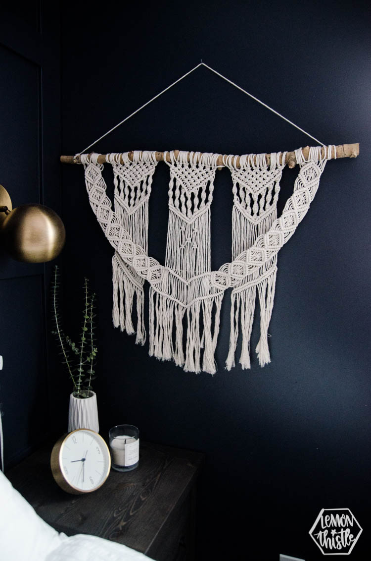 modern macrame wall hanging on navy wall