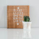 white plant pot holding cactus with floral monograms spelling 'grow' in champagne colored matte foil; in front of wooden letterboard that reads; plant ladies are the new cat ladies