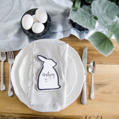 Easter bunny shaped black and white place card at natural pastel easter place setting