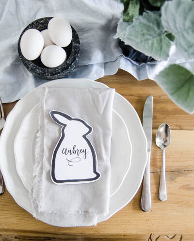 Easter bunny shaped black and white place card at natural pastel easter place setting