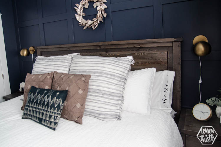 Bed made with white sheets and pillowcases hand lettered 'mine' and 'yours'