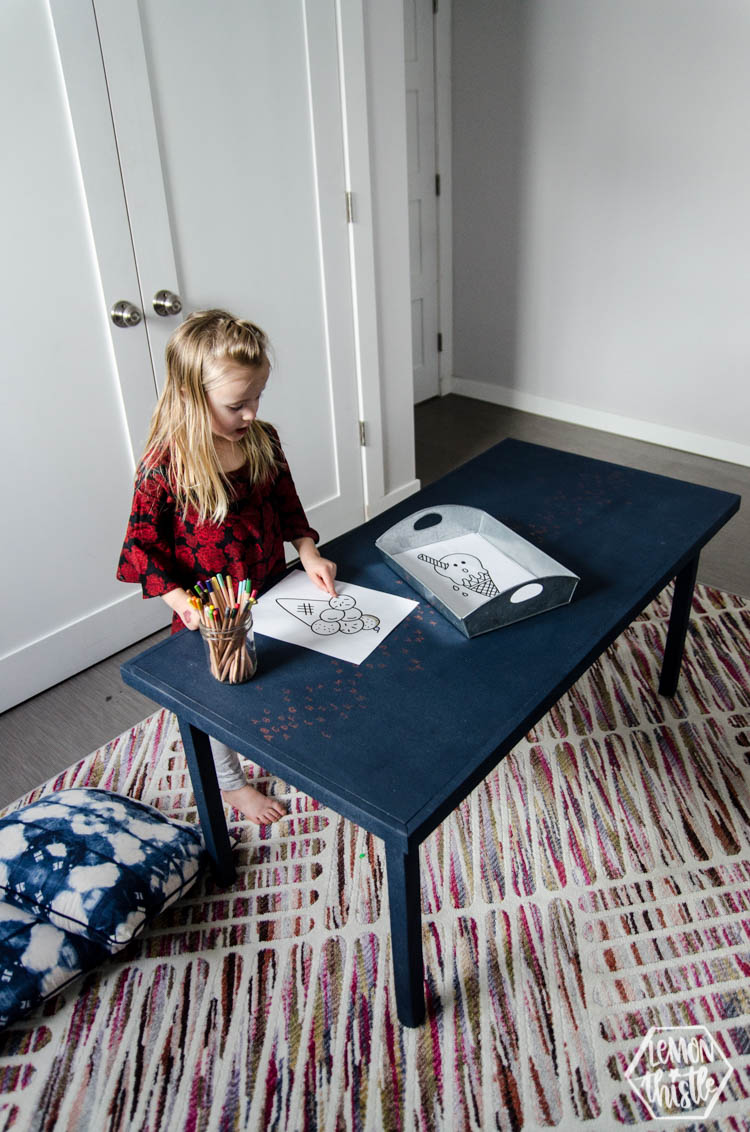 Drawing at a navy kids play table
