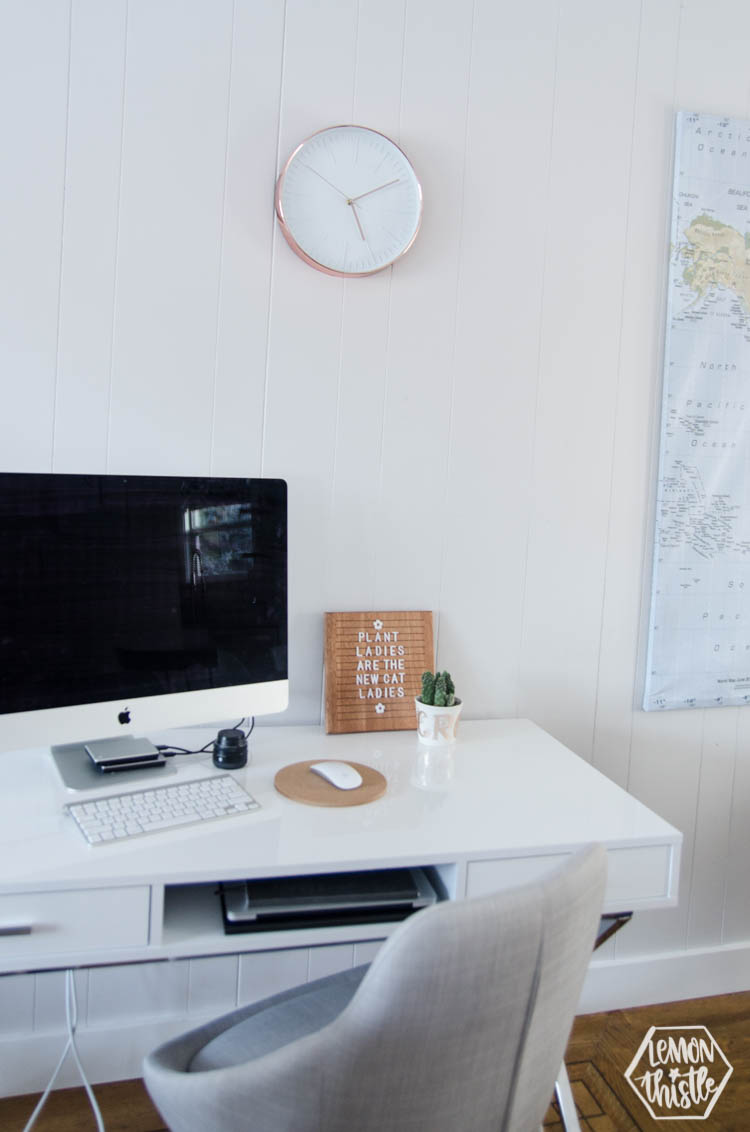 Bright white Desk in main living area with wooden letterboard